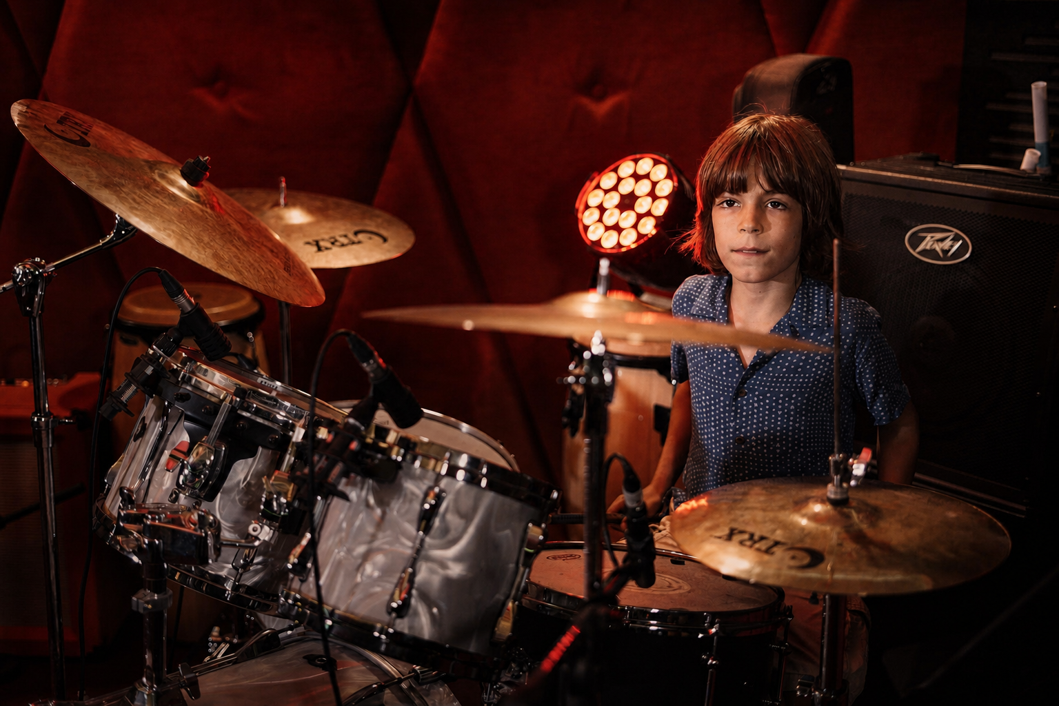 Musician performing at a drum kit.