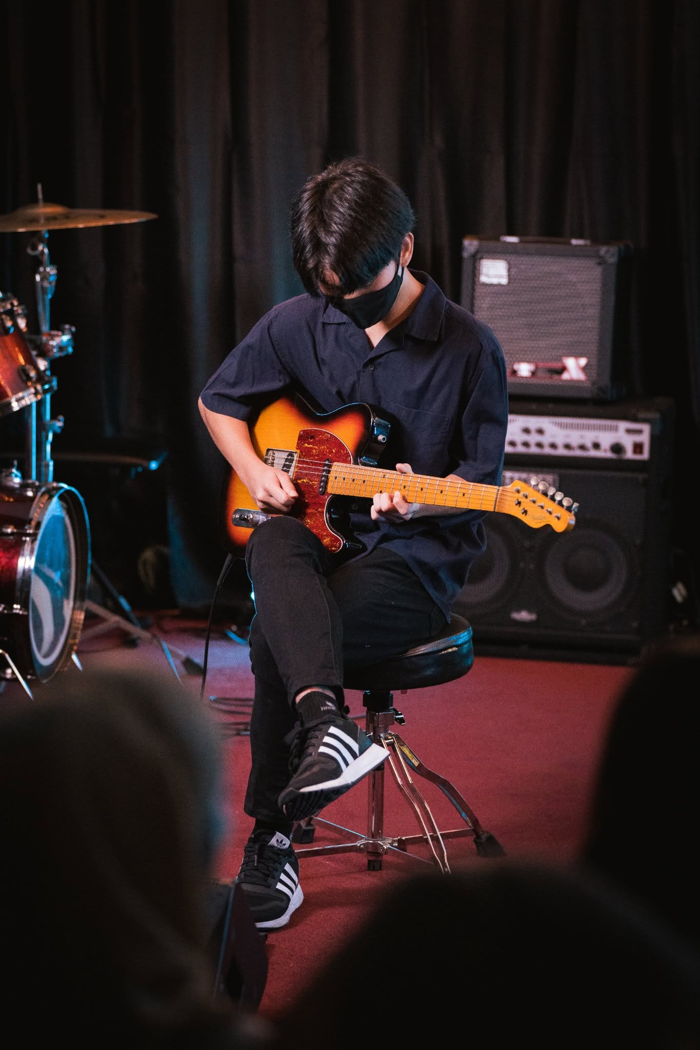 Person playing an electric guitar.