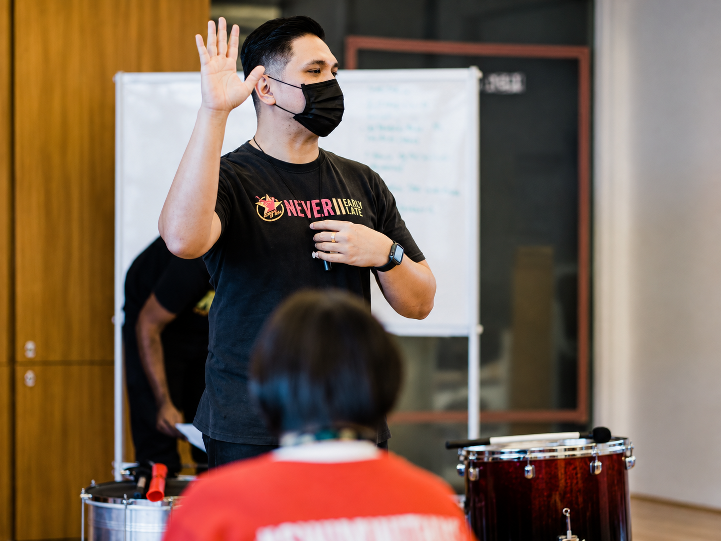 Academy of Rock instructor guiding a percussion class